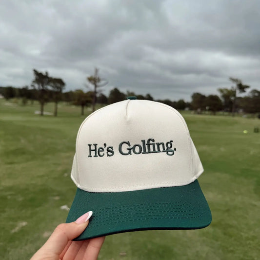 He's Golfing Trucker Hat